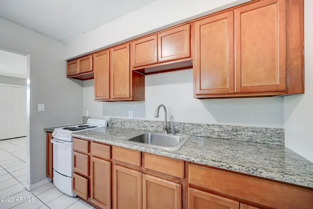 a kitchen with stainless steel appliances granite countertop a sink and cabinets