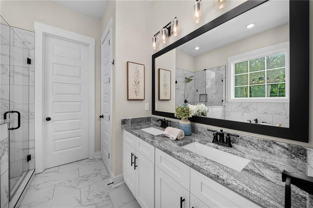 392 London Road Ball Ground, GA 30107 - Photo 18 of 53 a bathroom with a granite countertop sink and a mirror