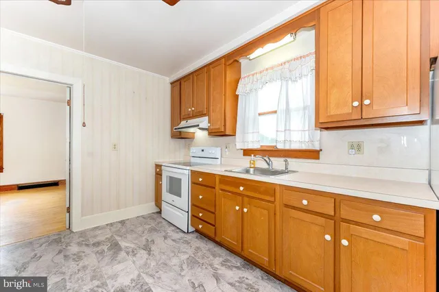 a kitchen with sink cabinets and window