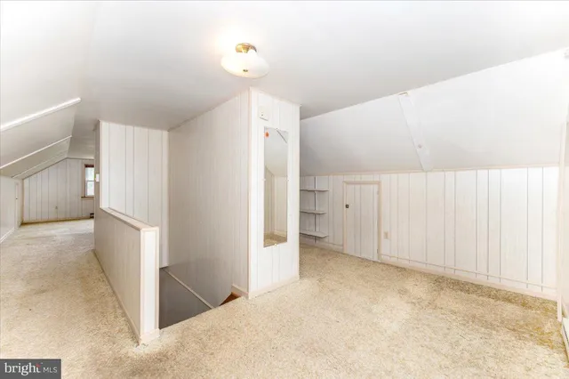a view of a kitchen with refrigerator and white cabinets