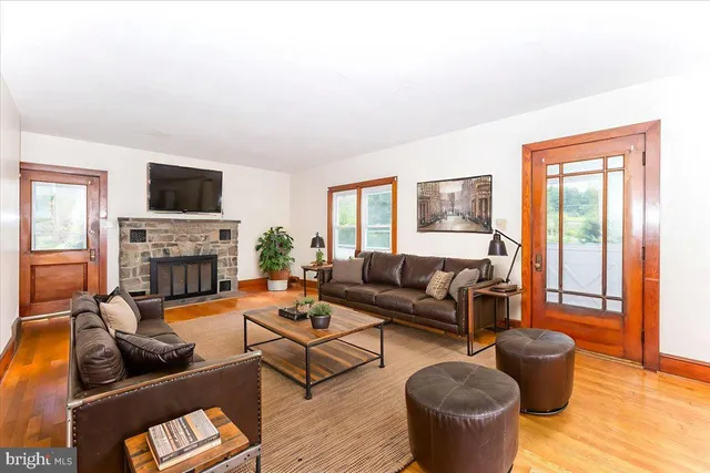 a living room with furniture a flat screen tv and a fireplace