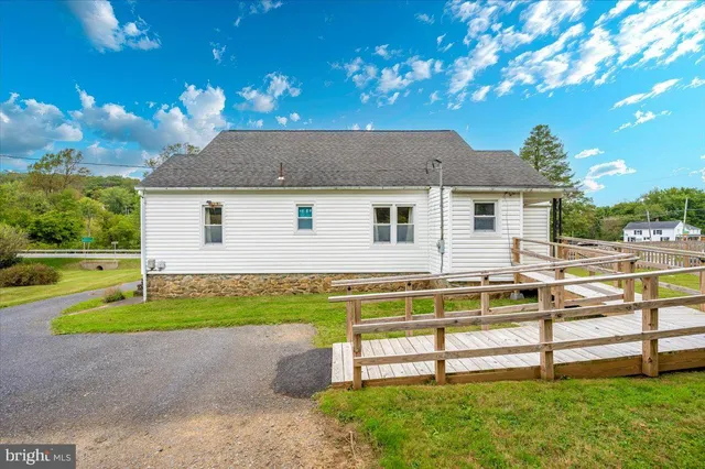 a view of a house with backyard and a tree