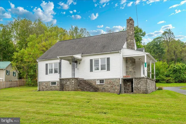 a front view of house with yard and green space