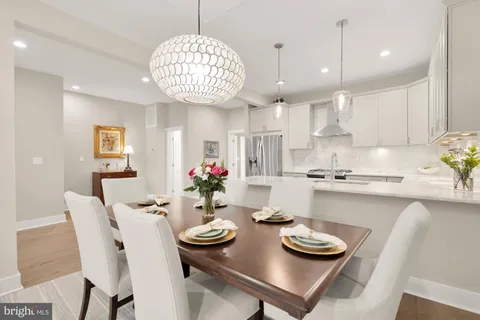 a kitchen with a dining table and chairs