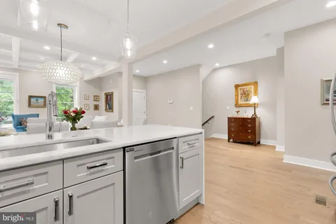 a kitchen with kitchen island a counter space a sink and a large mirror