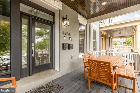 a front view of a house with outdoor seating