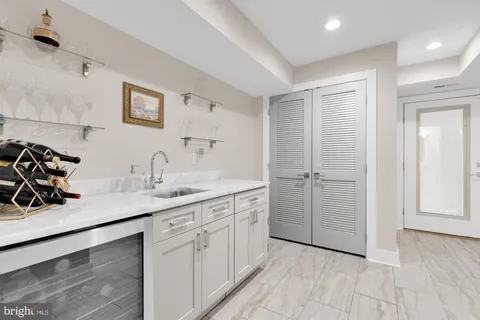 a kitchen with a sink cabinets and wooden floor
