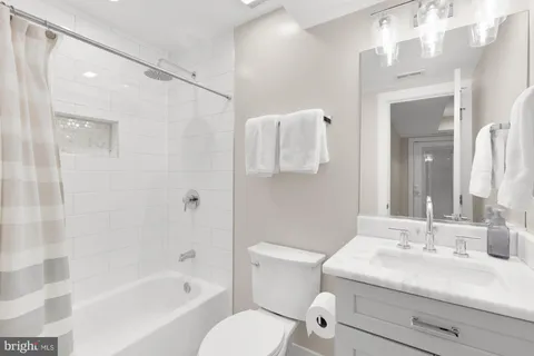 a bathroom with a sink toilet tub and shower