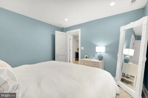 a large white bed in a white room