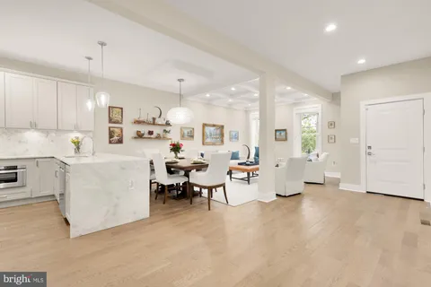 a large white kitchen with lots of white furniture