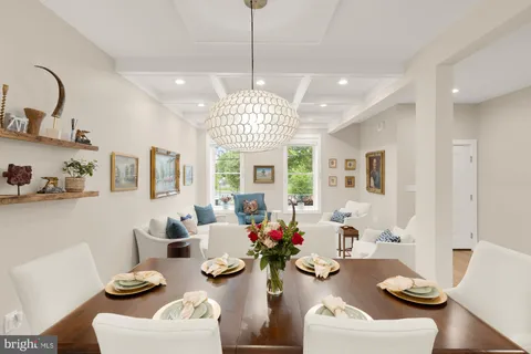 a very nice looking dining room with furniture window and wooden floor