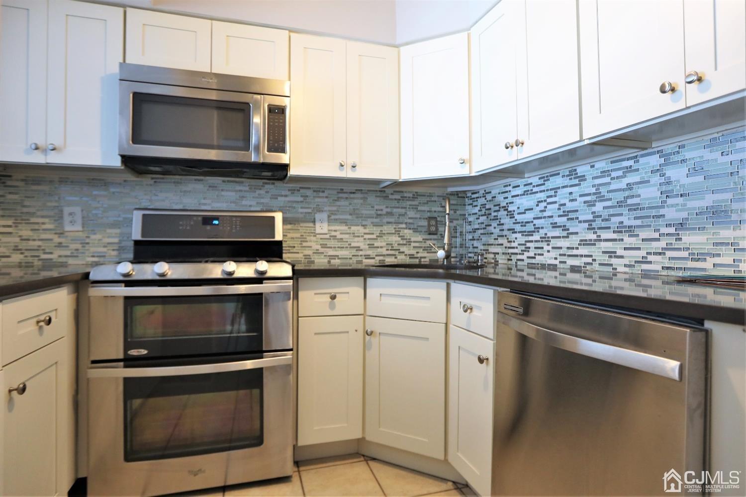 2303 Jesse Way Piscataway, NJ 08854 - Photo 1 of 9 a kitchen with granite countertop white cabinets and stainless steel appliances