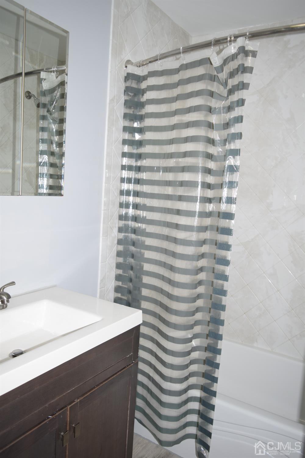 2303 Jesse Way Piscataway, NJ 08854 - Photo 2 of 9 a bathroom with a sink and a bathtub