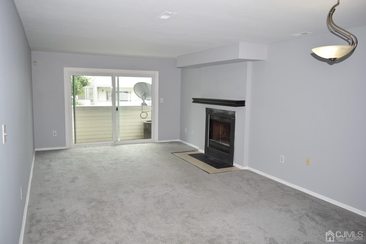 2303 Jesse Way Piscataway, NJ 08854 - Photo 3 of 9 an empty room with fireplace