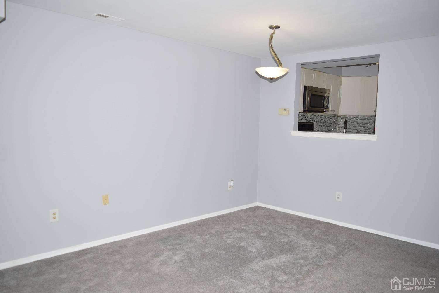 2303 Jesse Way Piscataway, NJ 08854 - Photo 4 of 9 an empty room with wooden floor and windows