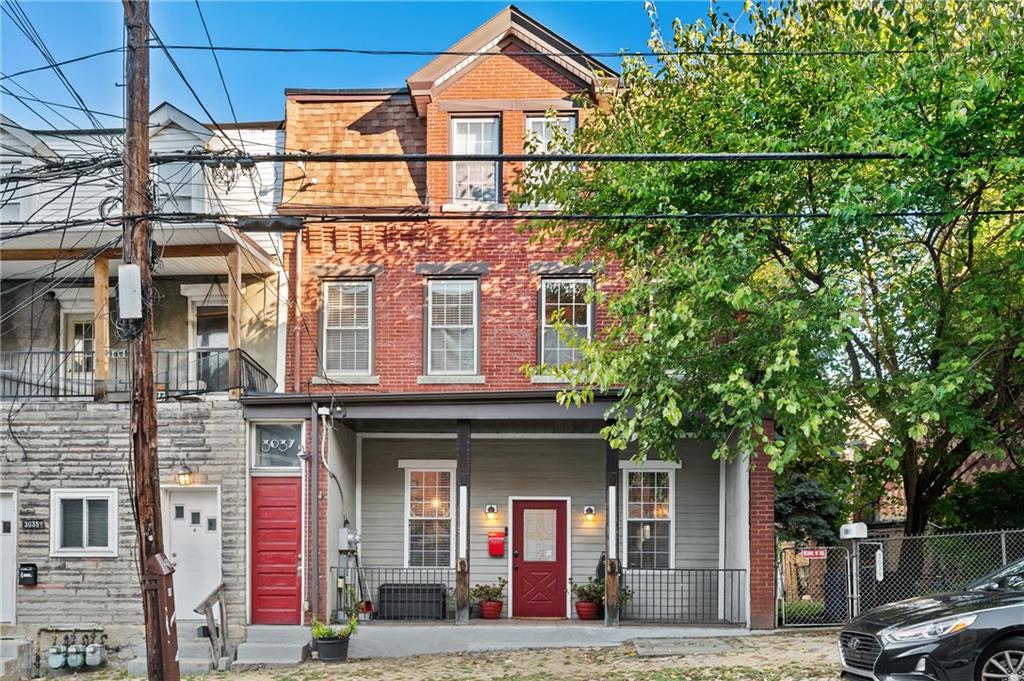 3037 Brereton Street Pittsburgh, PA 15219 - Photo 1 of 36 a front view of a residential apartment building with a yard