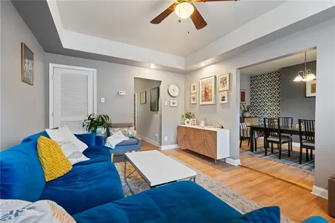 a living room with furniture and wooden floor