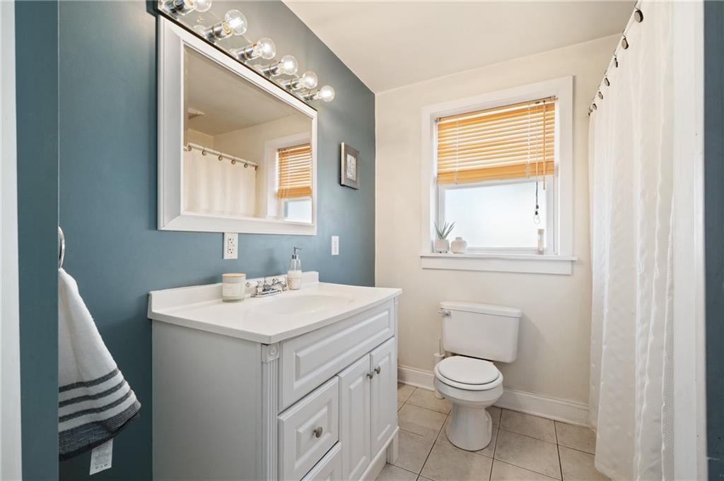3037 Brereton Street Pittsburgh, PA 15219 - Photo 15 of 36 a bathroom with a toilet a sink and a mirror