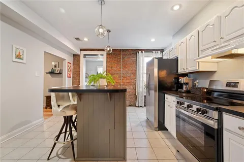 a kitchen with stainless steel appliances granite countertop a refrigerator a stove a sink dishwasher and a refrigerator