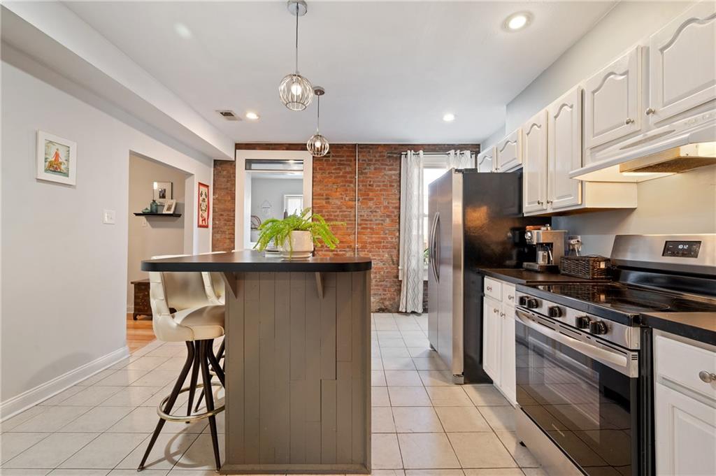 3037 Brereton Street Pittsburgh, PA 15219 - Photo 17 of 36 a kitchen with stainless steel appliances granite countertop a refrigerator a stove a sink dishwasher and a refrigerator