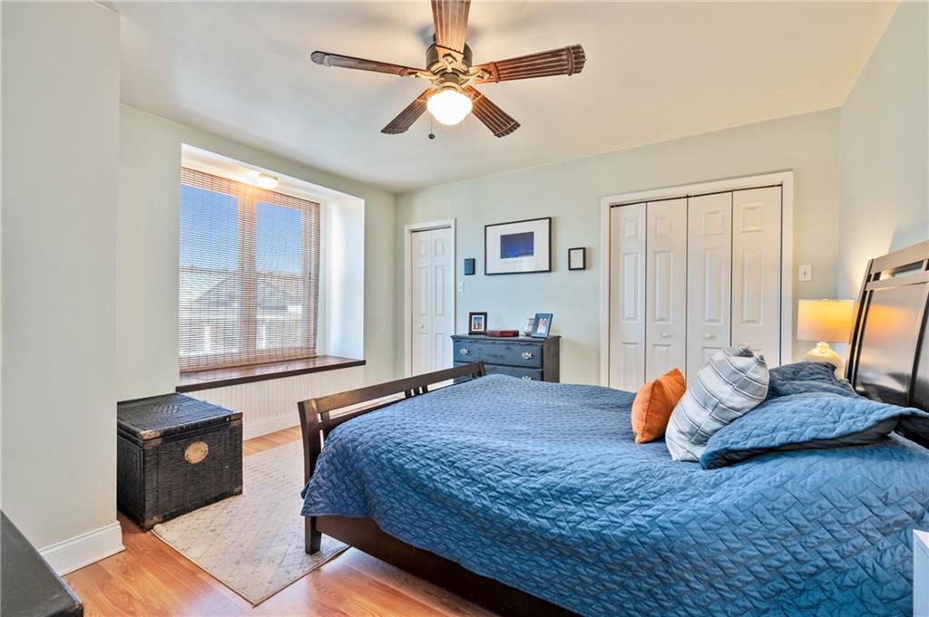 3037 Brereton Street Pittsburgh, PA 15219 - Photo 20 of 36 a bedroom with a large bed and wooden floor