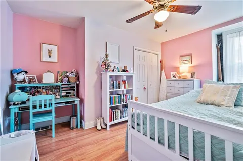 a bedroom with furniture and a book shelf