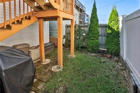 a backyard of a house with plants and outdoor seating