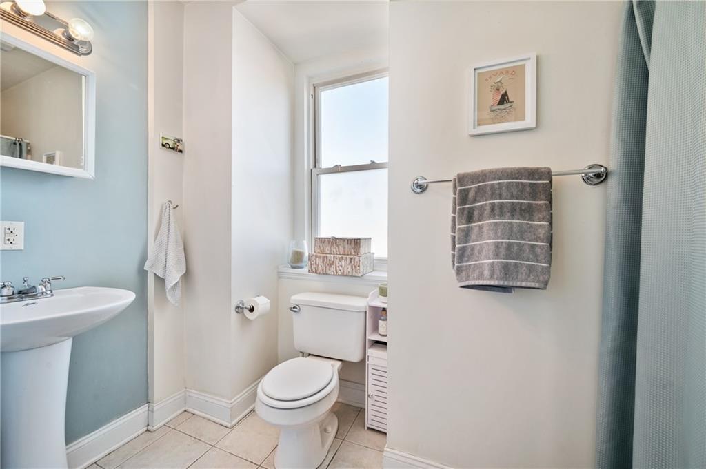 3037 Brereton Street Pittsburgh, PA 15219 - Photo 28 of 36 a bathroom with a granite countertop toilet a sink and a mirror