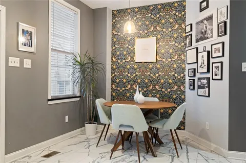 a view of a dining room with furniture and chandelier