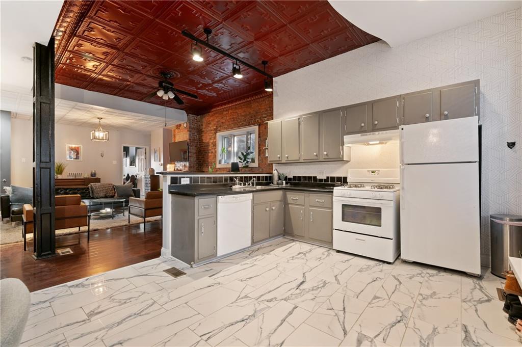 3037 Brereton Street Pittsburgh, PA 15219 - Photo 5 of 36 a kitchen with white cabinets and white appliances