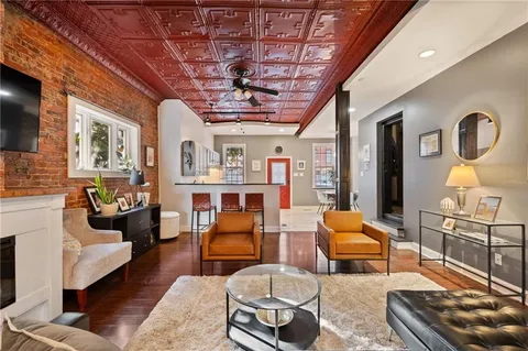 a living room with furniture and a chandelier