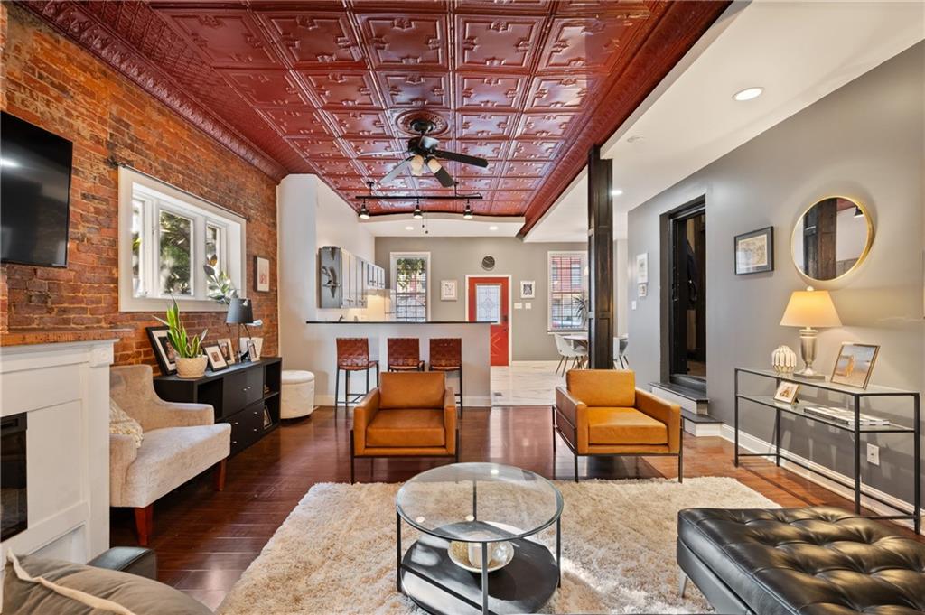 3037 Brereton Street Pittsburgh, PA 15219 - Photo 7 of 36 a living room with furniture and a chandelier