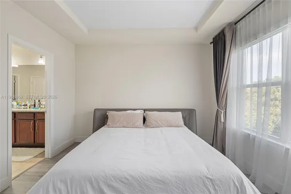 a bedroom with a large bed and a window