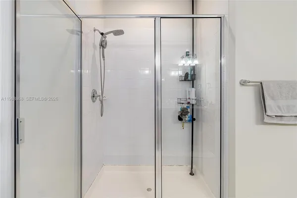 a bathroom with a glass shower door