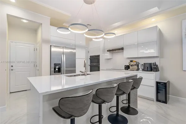 a large kitchen with a table and chairs