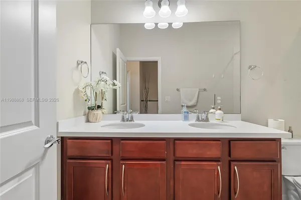 a bathroom with a granite countertop sink a mirror and a vanity