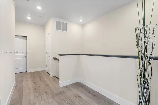 an empty room with wooden floor and a window