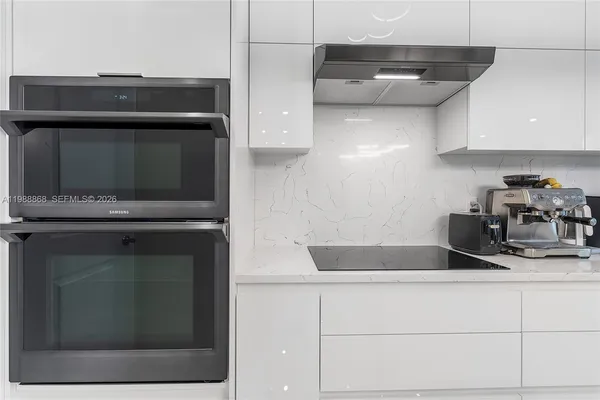 a kitchen with a stove and a microwave