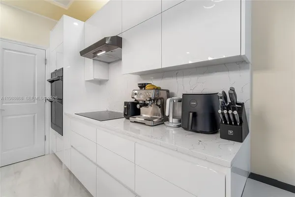 a kitchen with refrigerator and cabinets