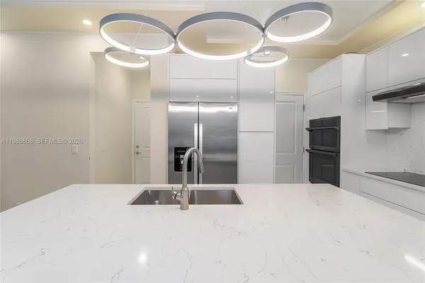a kitchen with stainless steel appliances a refrigerator and sink
