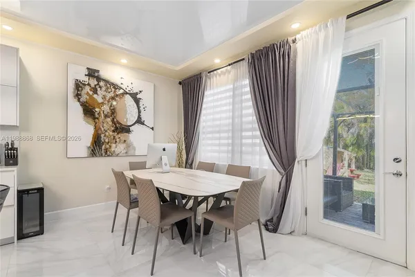 a view of a dining room with furniture and window