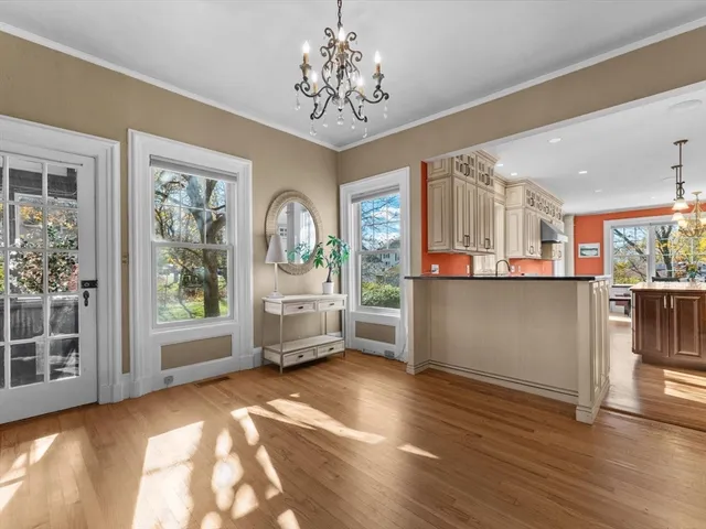 a view of a living room and kitchen with furniture large windows
