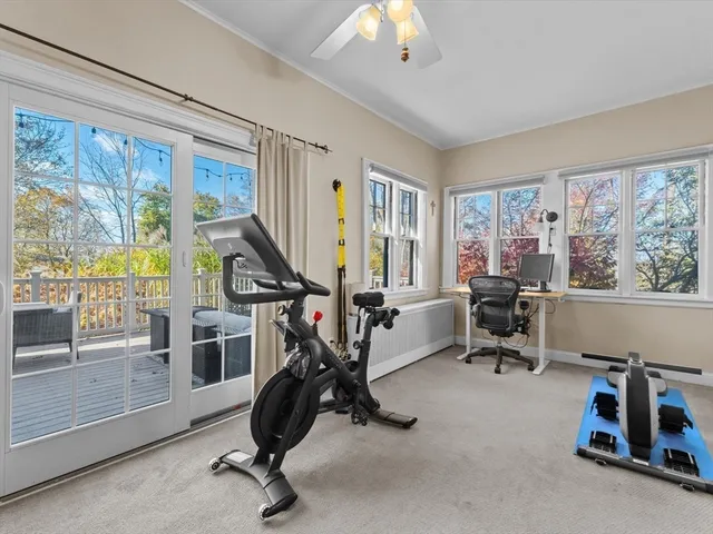 a view of a livingroom with workspace and windows