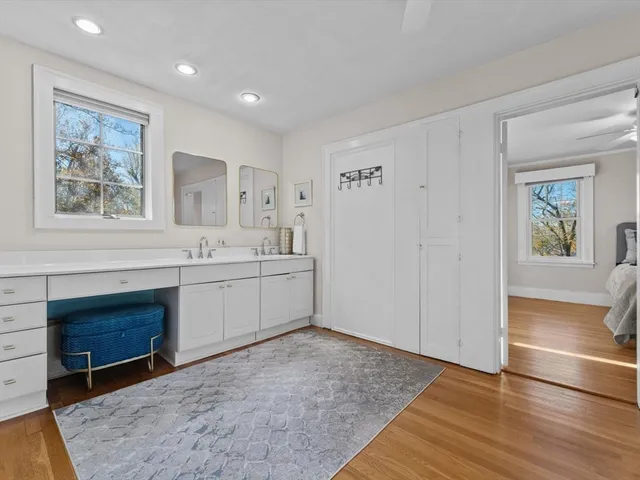 a view of cabinets a sink and a stove in a room