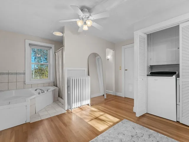 a living room with a bed furniture and a window