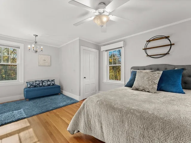 a spacious bedroom with a bed and dresser