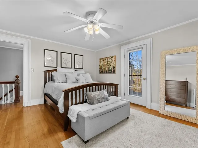 a spacious bedroom with a bed a couch and a chandelier