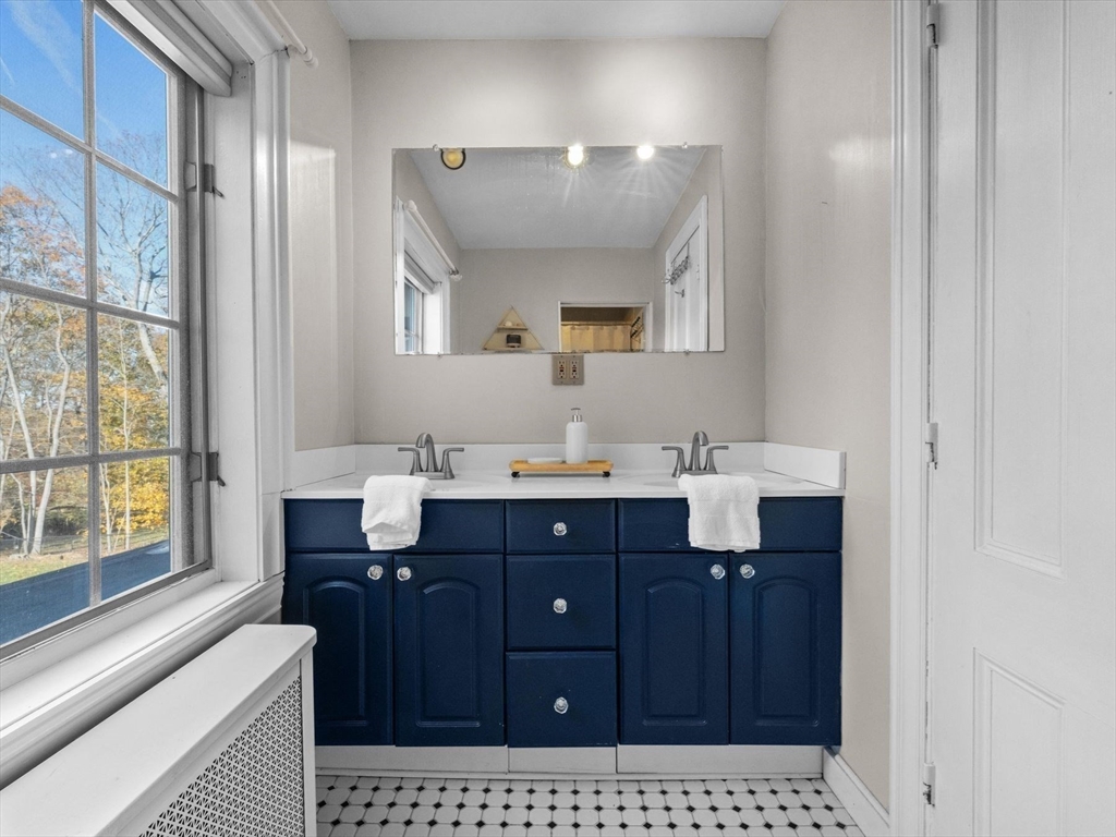 17 Worcester Street Grafton, MA 01519 - Photo 31 of 42 a bathroom with a sink a vanity and a large mirror