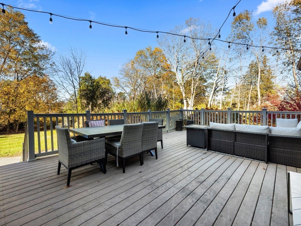 17 Worcester Street Grafton, MA 01519 - Photo 37 of 42 a view of a roof deck with table and chairs with wooden floor