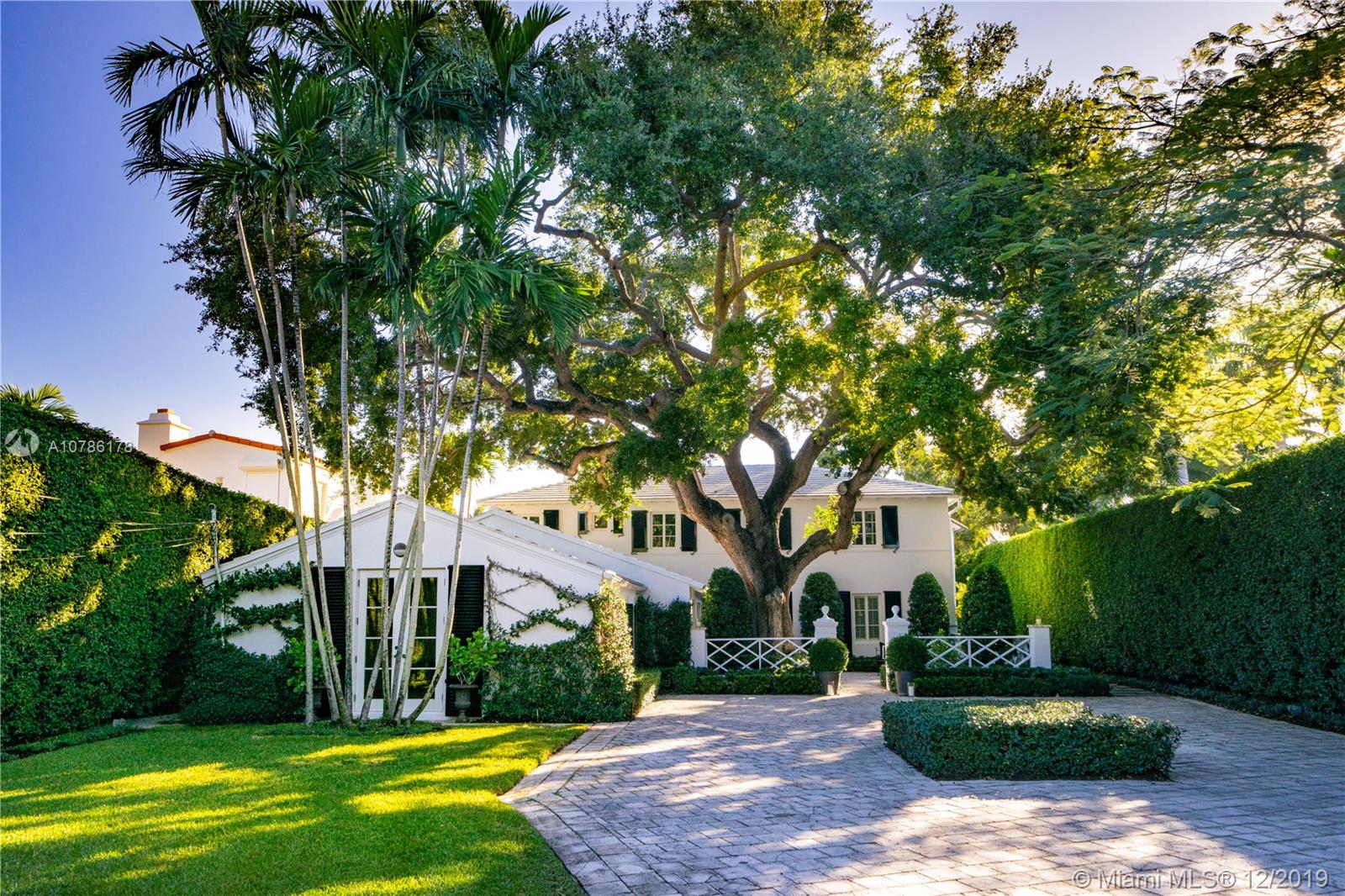 4955 Lakeview Drive Miami Beach, FL 33140 - Photo 11 of 55 a tree in front of a white house